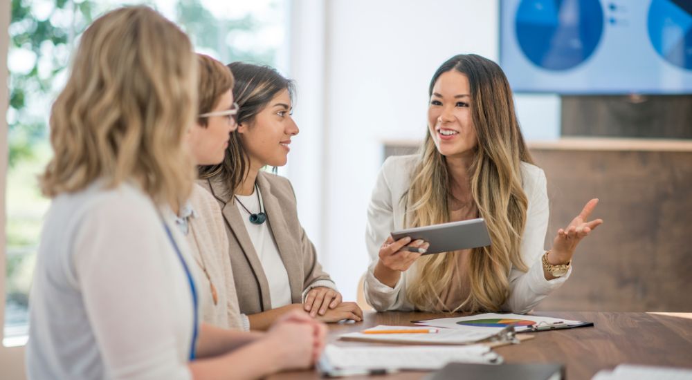 women in a conference room at work